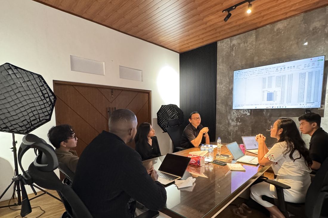 Francis Mugume in a team meeting at the office